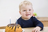 Small boy with birthday cake (gugelhupf)