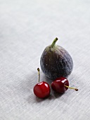 Two cherries and a fig
