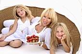 Mother and daughters with strawberries