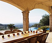 Dining table with mandarin oranges on roofed terrace