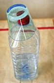 A glass on a plastic water bottle