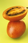 Whole and half tamarillo (tree tomato)