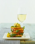 Tomato slices with basil and a glass of white wine