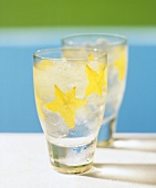 Two summer drinks on the rocks with star fruit