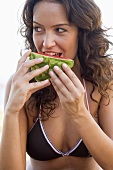 Woman eating a piece of watermelon