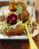 Baked potato with sour cream, herbs and vegetables