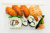 Assorted sushi in a plastic container