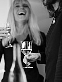 Man with wine glass, laughing woman with glass of sparkling wine