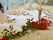 Glasses and candlestick on festive table