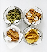 Four tins of different savoury snacks