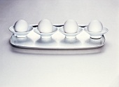 Four eggs in eggcups on a tray