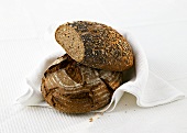 Two loaves of bread on a tea towel