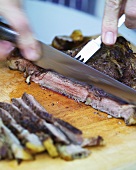 Slicing a fried beef steak