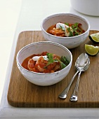 Tomato soup with prawns, sour cream and coriander leaves