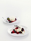 Two yoghurt parfaits with berry sauce