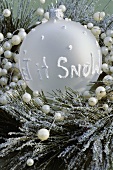 Winter arrangement, bauble with the words Let it snow