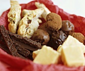 Chocolates and sweets in a bowl with paper