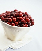 A dish of cranberries on fabric napkin