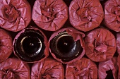 Wine Glasses Wrapped in Red Tissue Paper; Two Unwrapped