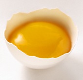 An Egg Yolk in a Piece of White Egg Shell