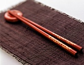 Red Chopsticks with Holder on Black Placemat