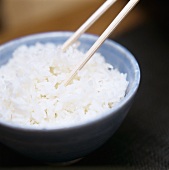 A Bowl of Cooked White Rice with Chopsticks