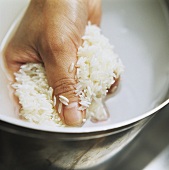 A Handful of Rice Being Rinsed