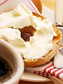 A Toasted Bagel with Cream Cheese and Coffee