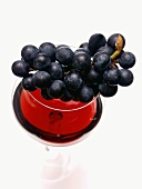 Grapes Resting on a Glass of Red Wine