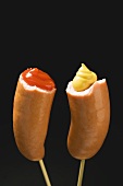 Sausages with ketchup & mustard on wooden cocktail sticks