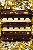 Bars of dark and white chocolate on gold foil