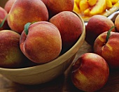 Fresh Peaches In and Beside a Bowl