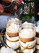 Mehrere Gläser heiße Schokolade mit Marshmallows