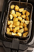 Deep fried potatoes in a frying basket
