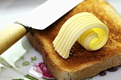 A slice of toast with a curl of butter