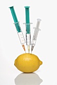 A lemon stuck with syringes