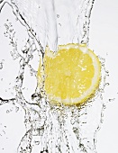 Half a lemon under flowing water