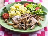 Pork fillet with mushrooms, mashed potatoes and salad