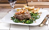 Beef fillet with spinach, bacon and pine nuts