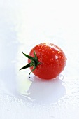 A freshly washed cherry tomato