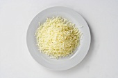 A plate of grated cheese, seen from above