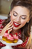 A retro-style girl with strawberry muffins