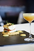 Cod fillet with pepper on chickpea puree and a cocktail