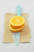 Two orange slices on a knife