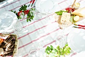 A table laid with glasses, crisp breads and butter