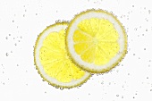 Two lemon slices in water with air bubbles