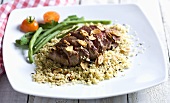 Beef with garlic on a bed of couscous