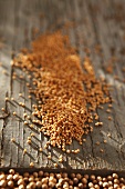 Mustard seeds on a wooden surface