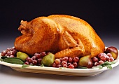 Whole Roasted Turkey on a Platter with Red Grapes and Pears