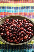 Fresh Cranberries in a Wooden Bowl on Colorful Cloth